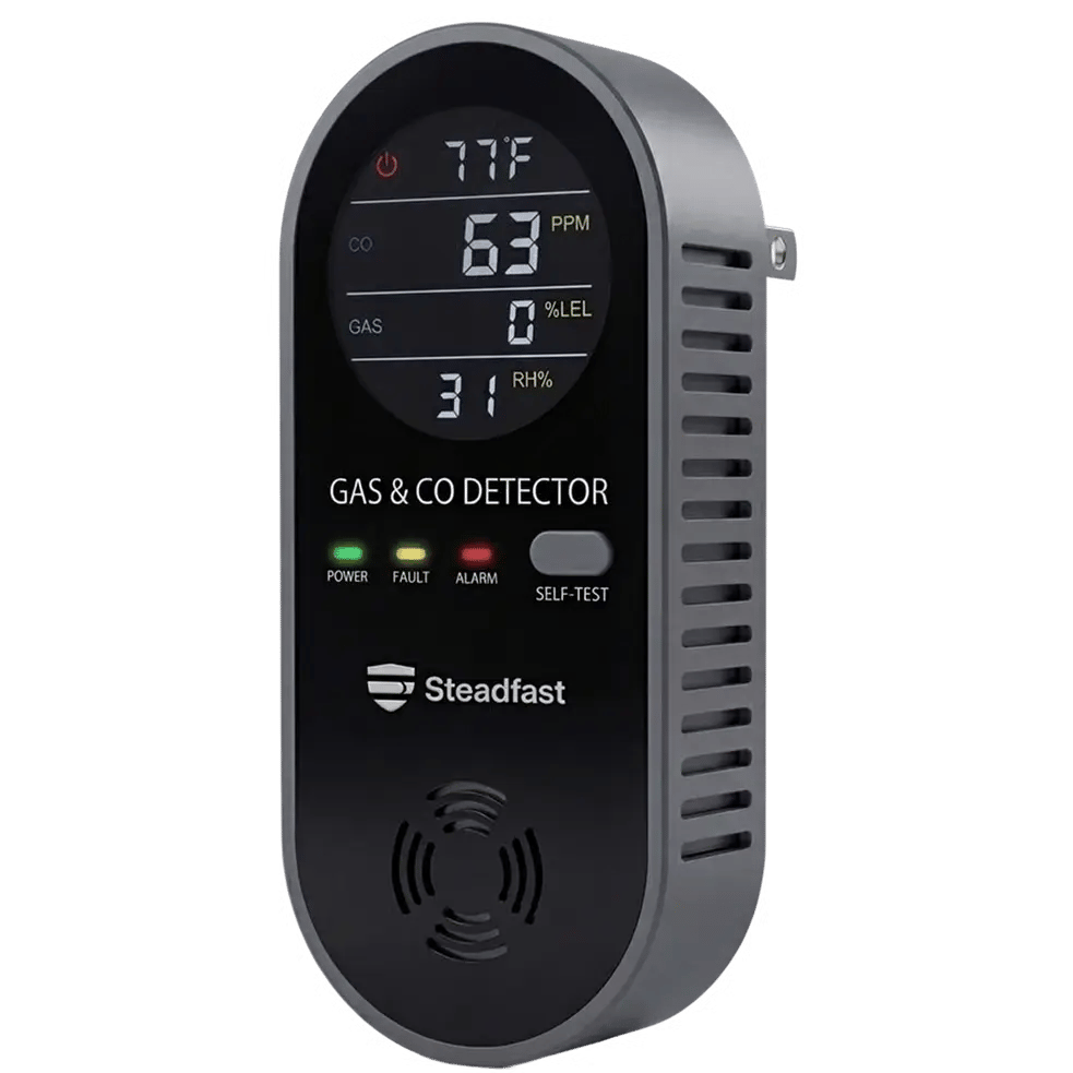 A black and grey Steadfast plug-in gas and carbon monoxide detector with a digital display.